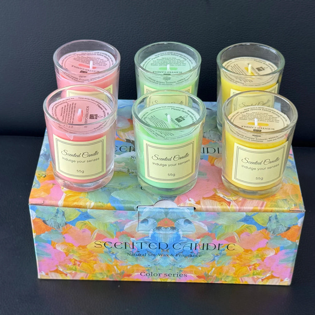 Aromatherapy candle gift box with pastel pink, green and yellow candles in glass jars