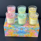 Aromatherapy candle gift box with pastel pink, green and yellow candles in glass jars