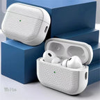 White leather AirPods case with earbuds in open case