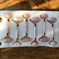 Set of pink rose quartz glow rollers with gold-tone metal and stone heads