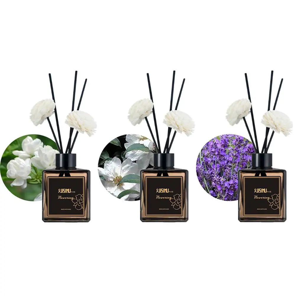 Reed diffuser set with three bottle displays and white flower-tipped reeds (scent options)