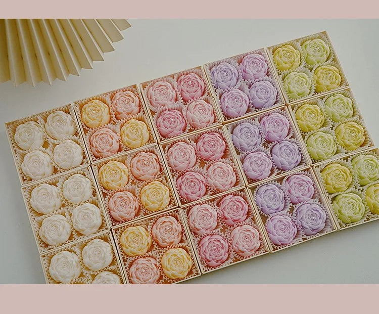 Rose-scented candle gift box with assorted pastel rose candles in a grid layout