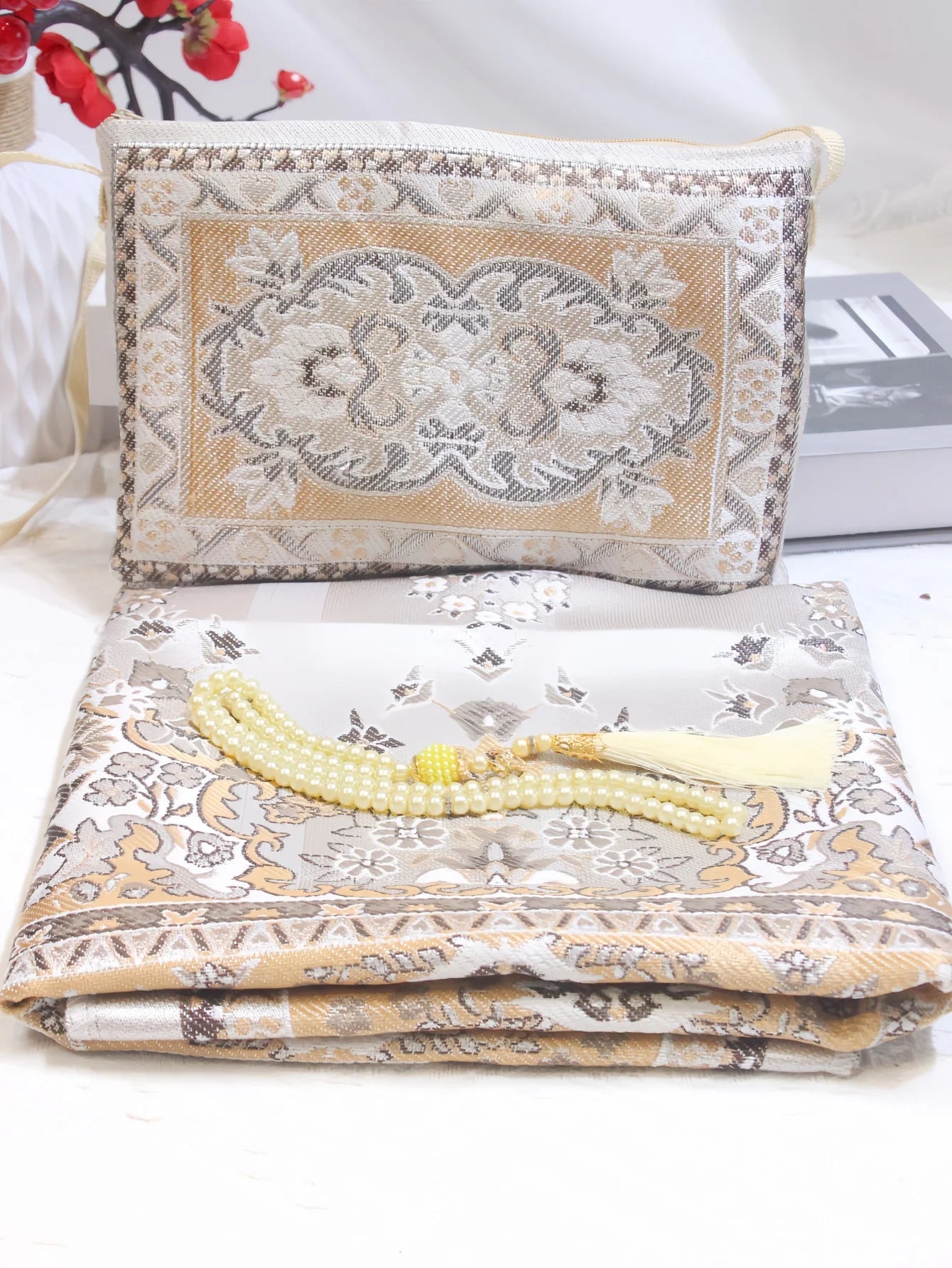 Prayer rug gift set with tan embroidered pouch, patterned mat, and yellow beaded tassel