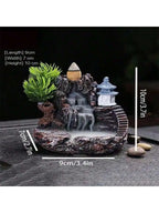 Waterfall backflow incense holder with green plant, lantern, and cascading smoke, size view