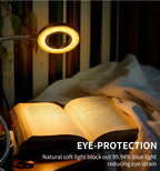 Cordless reading lamp with a glowing circular ring light above an open book