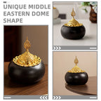 Ceramic oud burner with black dome body and gold openwork dome lid, decorative finial