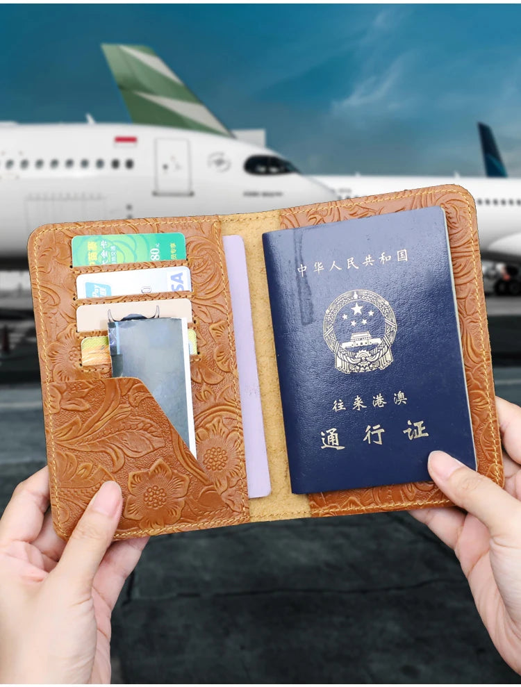 Tan leather travel folio opened flat, showing card slots and an identity document holder.