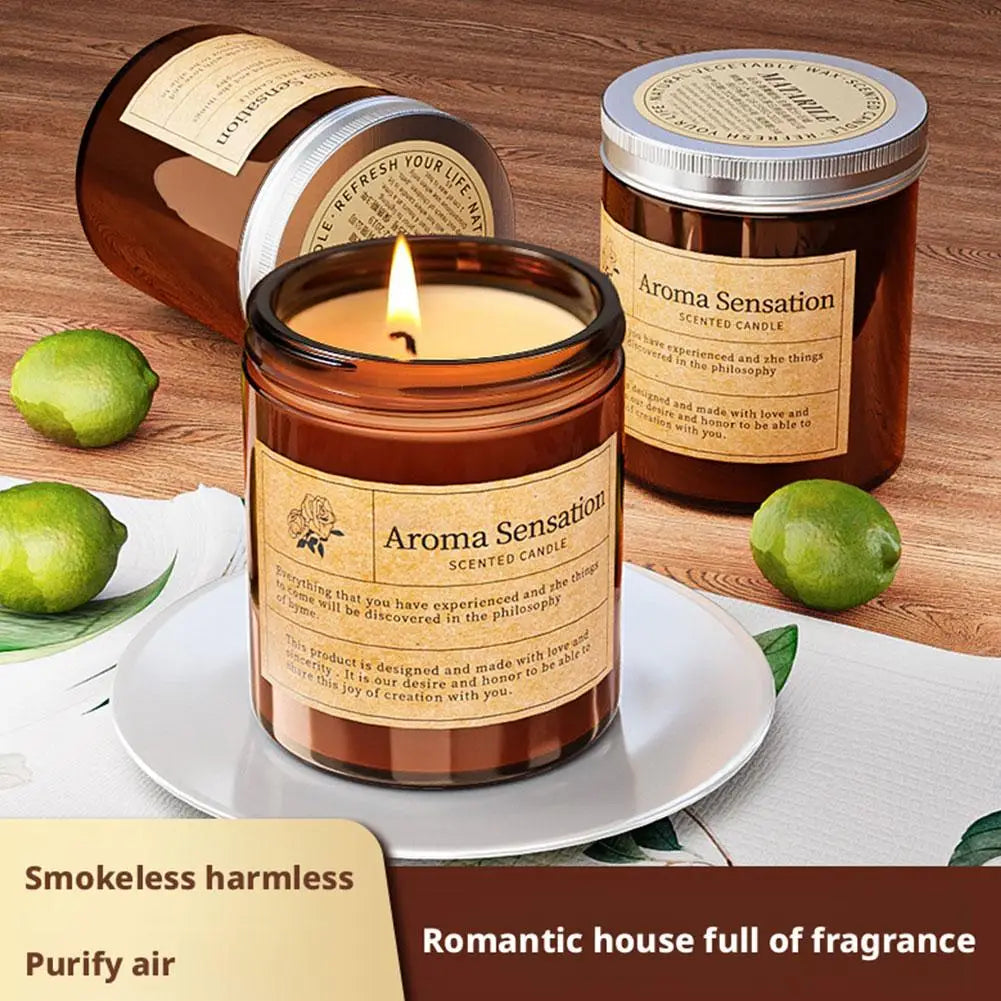 Amber scented candle jar lit on a plate, other jar lids behind it