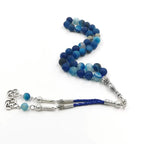 Blue agate prayer bead rosary with silver-tone centerpiece and braided tassel cords