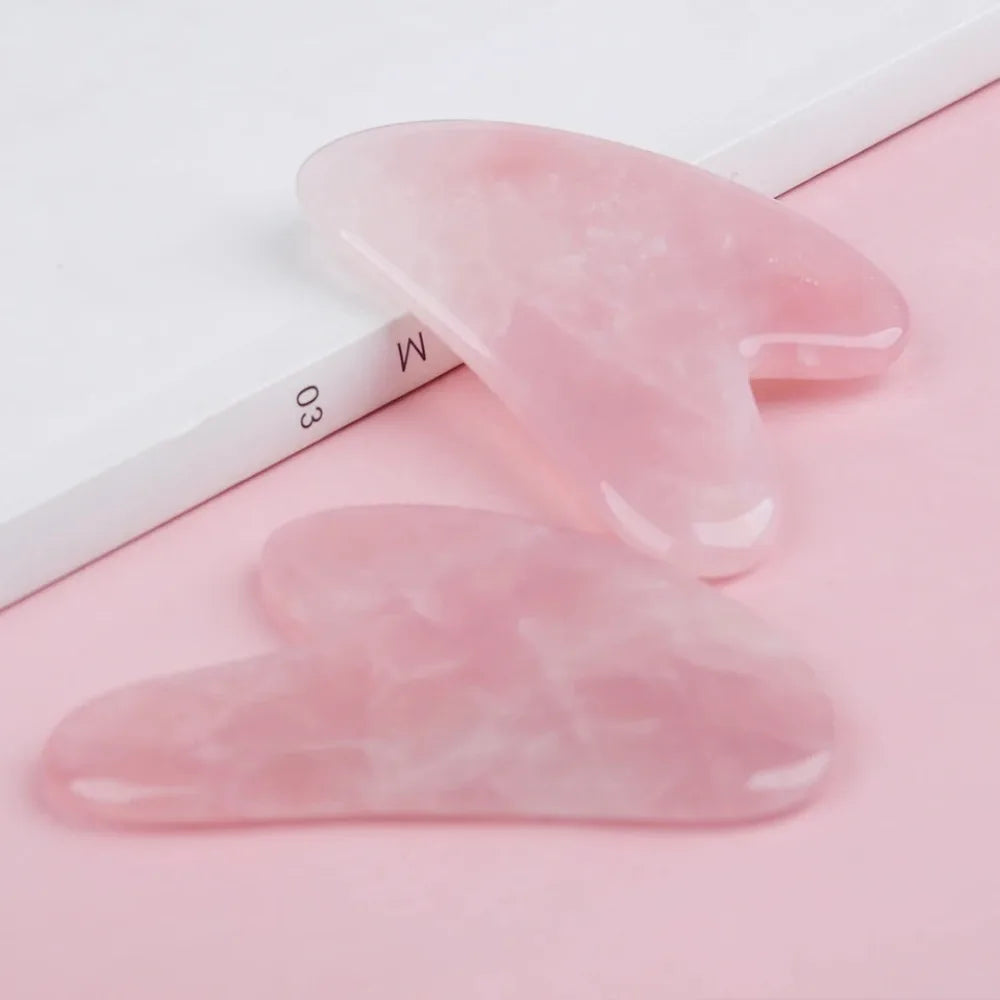 Rose quartz gua sha stone close-up with rounded corners and smooth finish