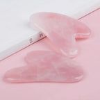 Rose quartz gua sha stone close-up with rounded corners and smooth finish