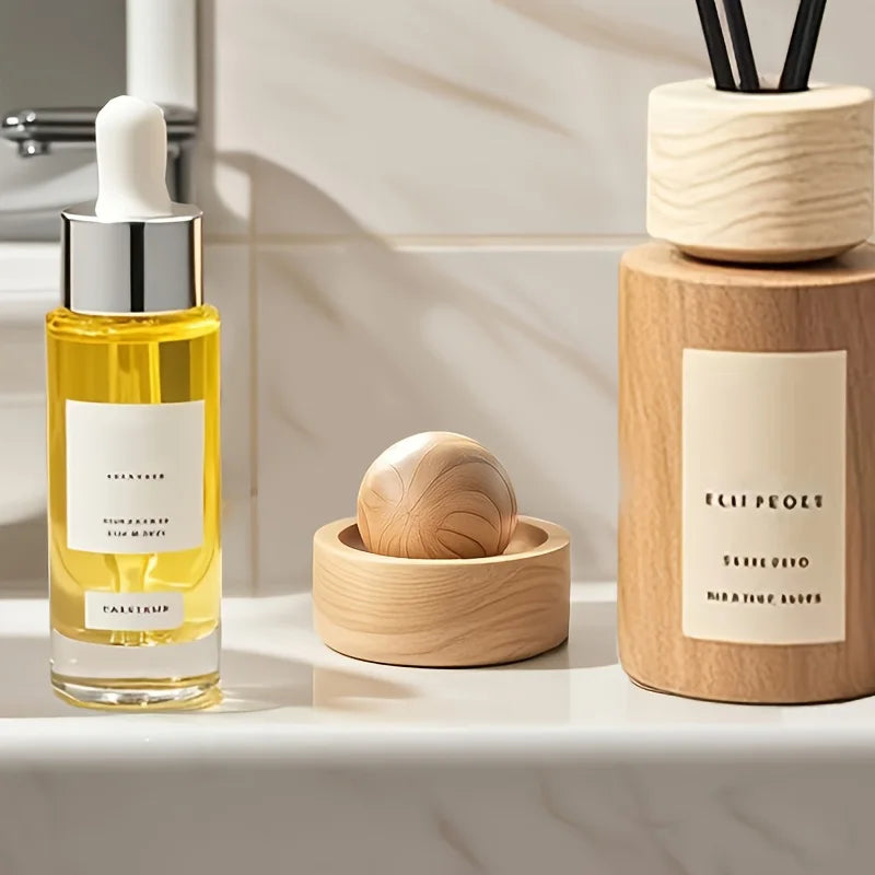Light wood mini aroma diffuser with carved spherical insert in round holder