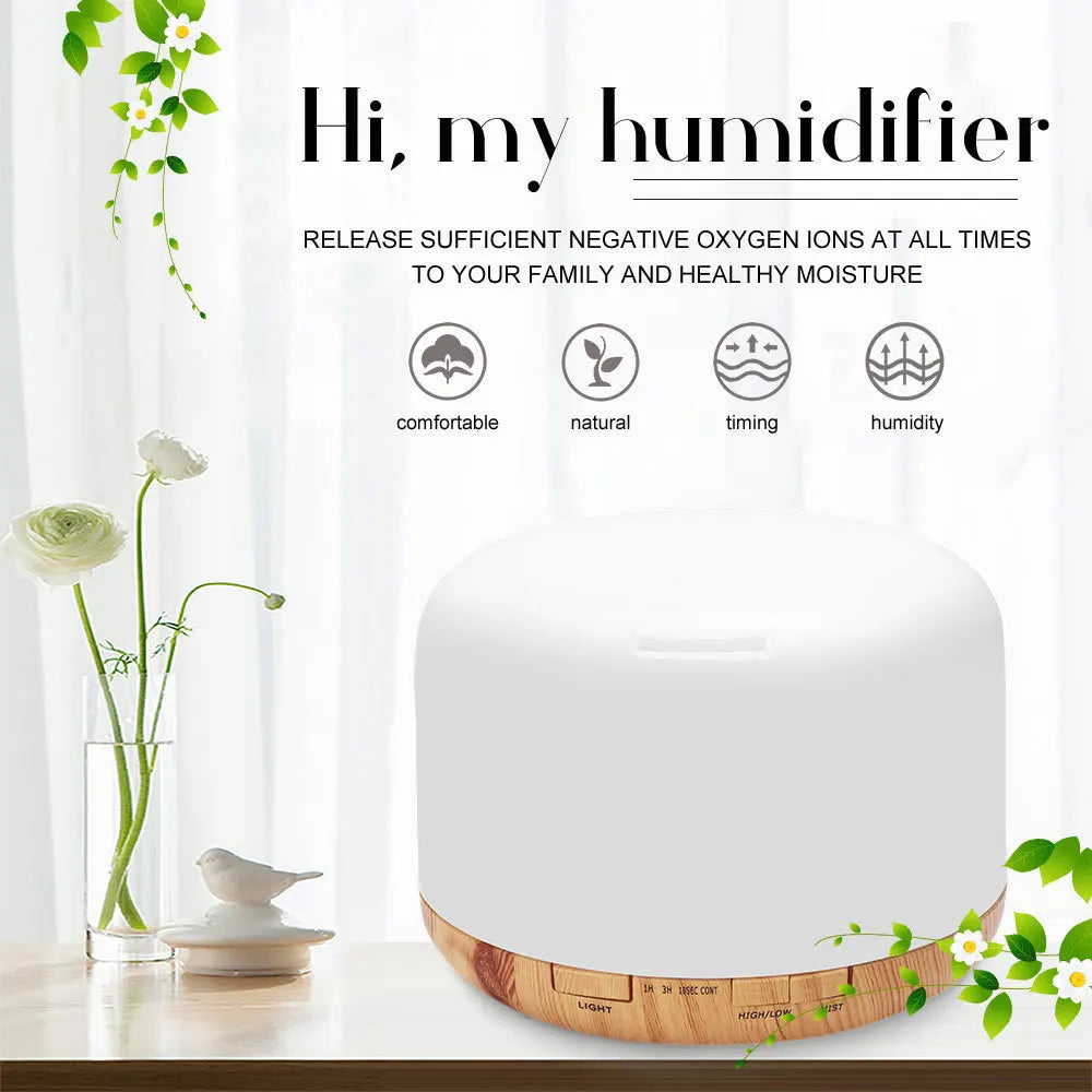 White aroma diffuser humidifier with dark wood base, round top with vent slot