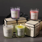 Lavender and coral glass scented candles with lit wicks in gift boxes