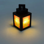 Black lantern night light with pixel pattern glowing orange and yellow through panels
