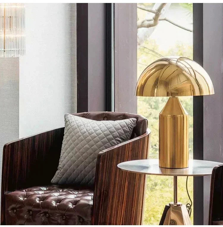 Gold mushroom LED table lamp with reflective dome and tall gold column base
