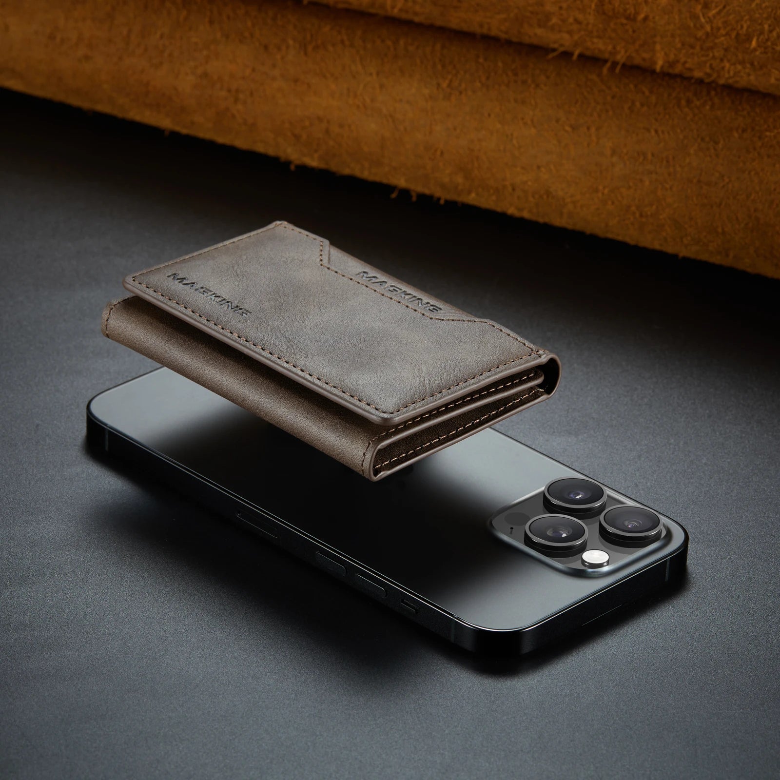 Gray slim leather wallet with card slots, attached to a phone, closed