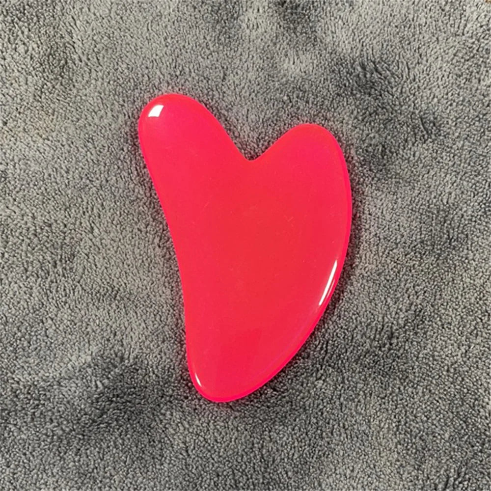 Carnelian red gua sha stone with glossy red, curved teardrop shape.