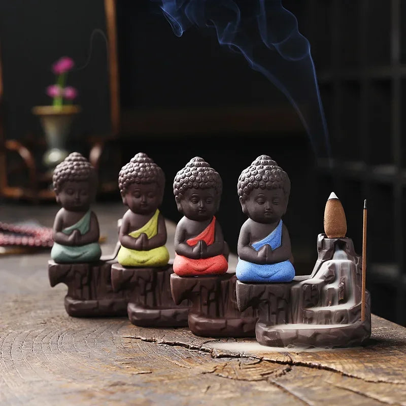 Backflow incense burner with seated Buddha figures and colorful robes, multi-finish set