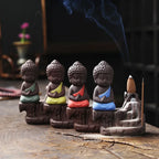 Backflow incense burner with seated Buddha figures and colorful robes, multi-finish set