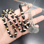 Tasbih prayer beads with black, gold, and dotted beads and silver medallion pendants