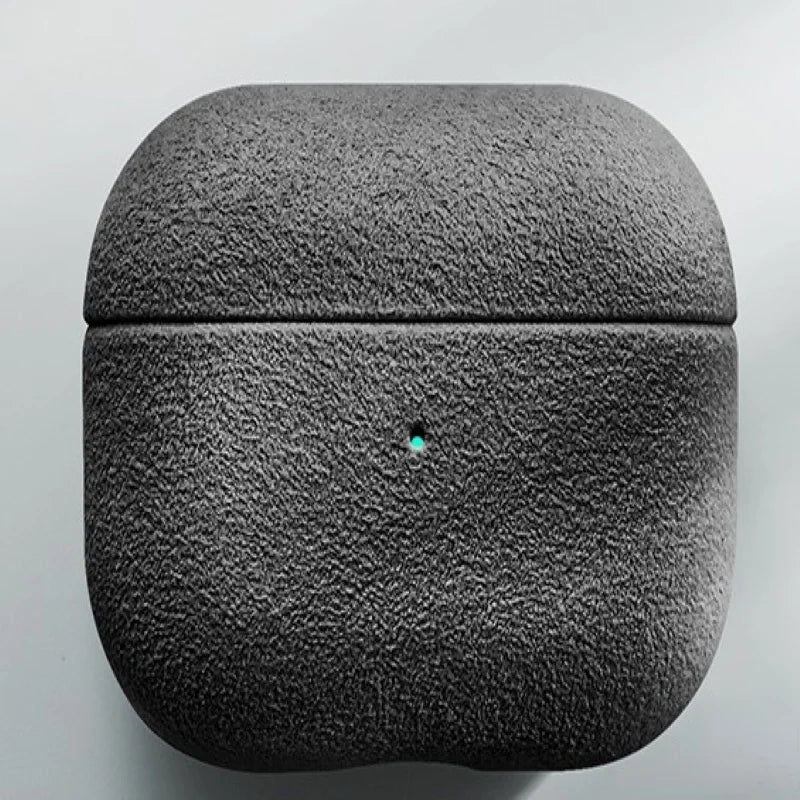 Italian suede AirPods case in Obsidian, closed case with visible charging-light pin