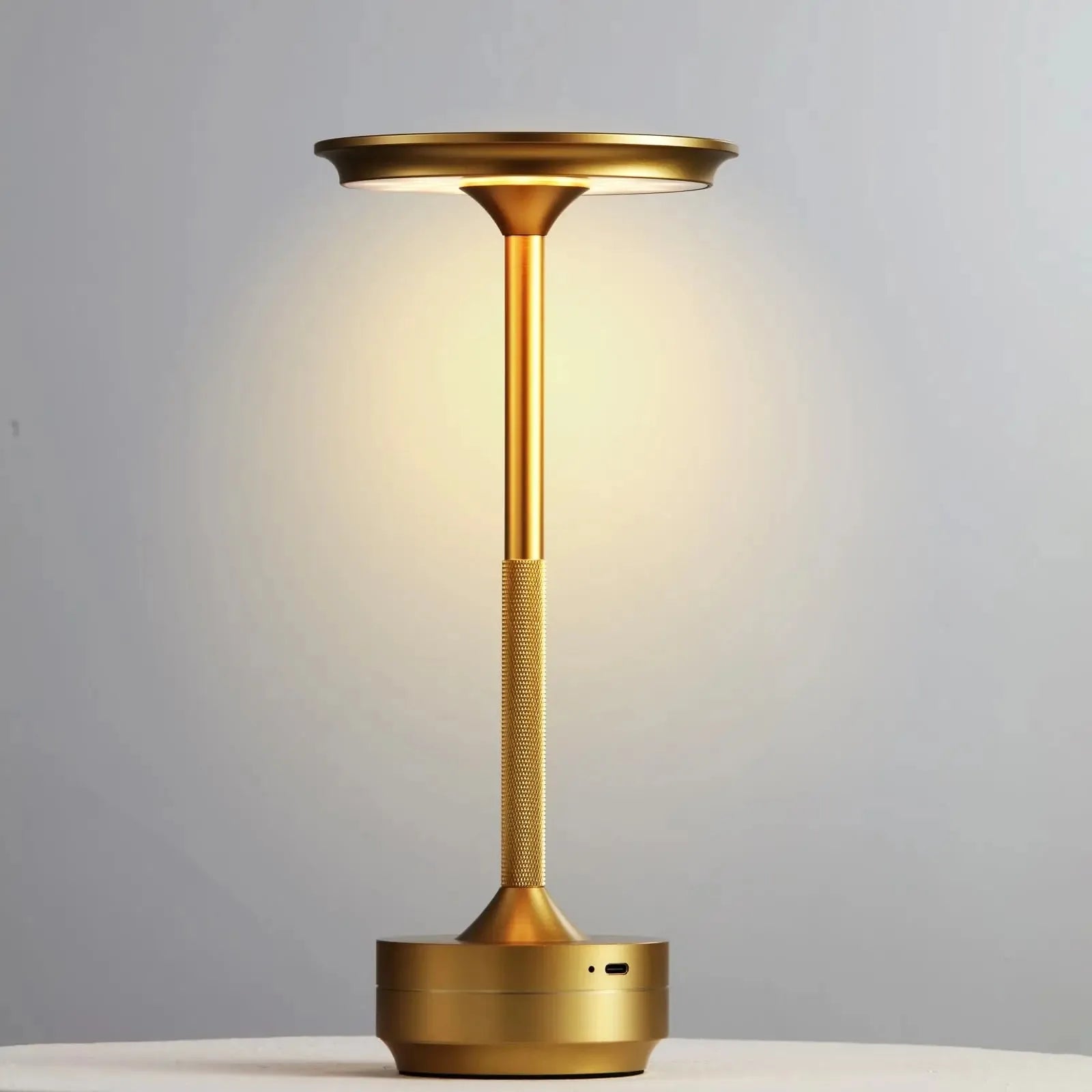 Champagne gold wireless touch lamp with circular top and tall slender base