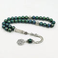 Tasbih misbaha with green-blue faceted 10mm beads and silver connector centerpiece
