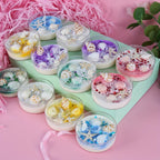 Seashell-scented candle assortment on a tray, glass cups with starfish and seashells