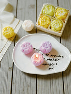 Rose scented candle gift set with purple and pink rose candles on a white plate