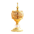 Gold incense tower holder with ornate cylinder, clear crystal base, and scalloped stand
