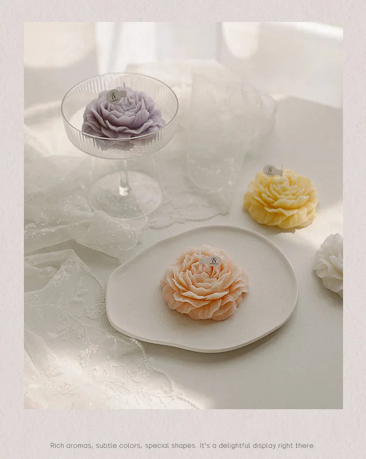 Lavender, yellow, and peach peony sculptural candles arranged on plates