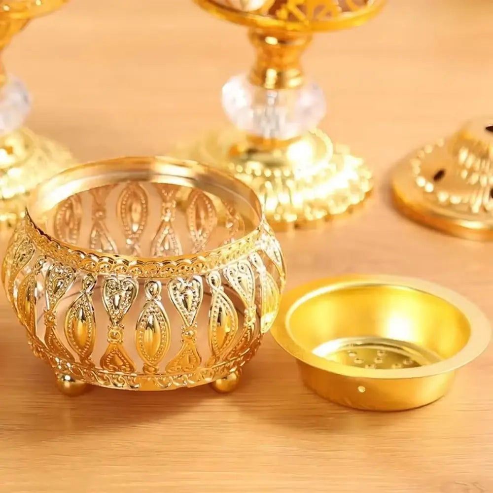 Close-up of gold incense bowl with cutwork pattern and attached dish insert