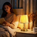 Cordless LED touch table lamp glowing on side table with champagne gold ribbed shade