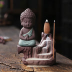 Backflow incense burner front view, jade-green robed Buddha with incense cone