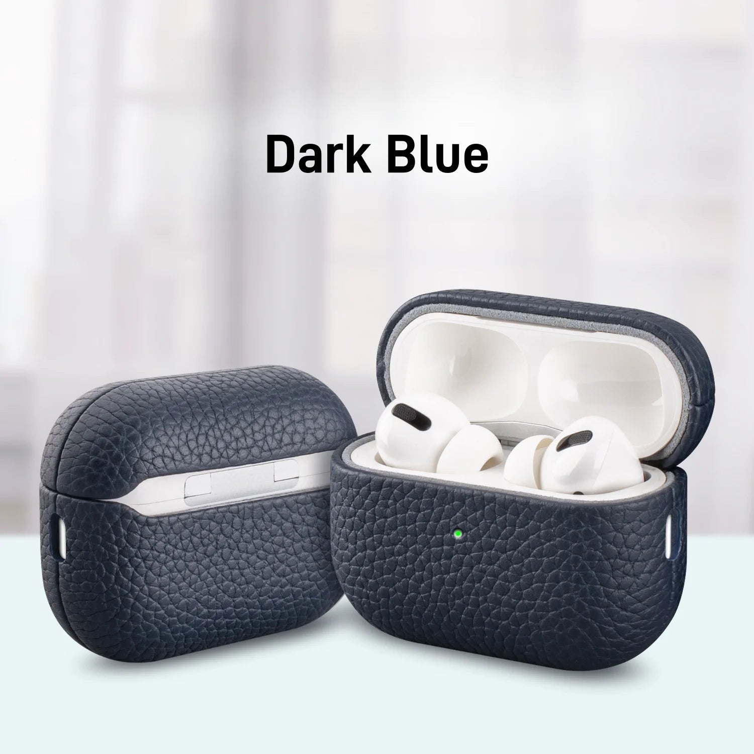 Dark blue MagSafe leather AirPods case with earbuds inside, lid open