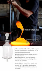 Glass essential oil diffuser with glowing mist pouring from a clear bottle