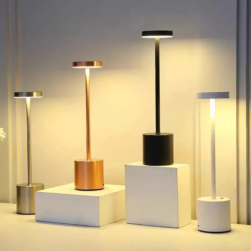 Champagne gold emitting color: lamp with gold stem and black base, glowing light bar