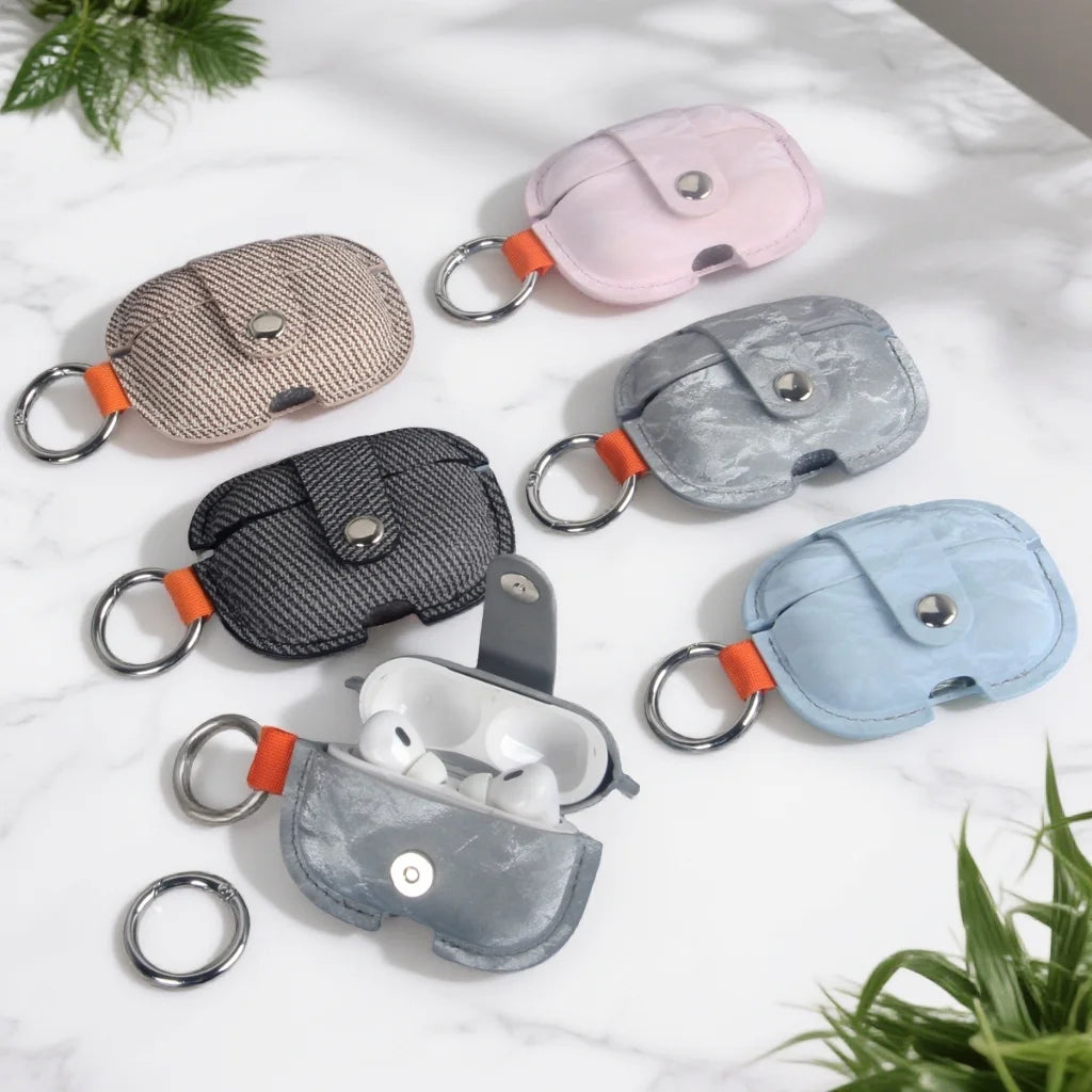 Soft PU AirPods cover set with key rings: pink, black, gray, and light blue