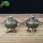 Set of two copper lotus incense burners with bird-topped lids on short feet