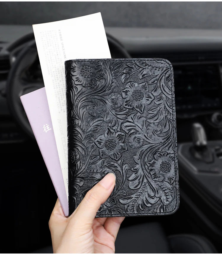 Midnight Black embossed leather travel folio held with papers tucked inside