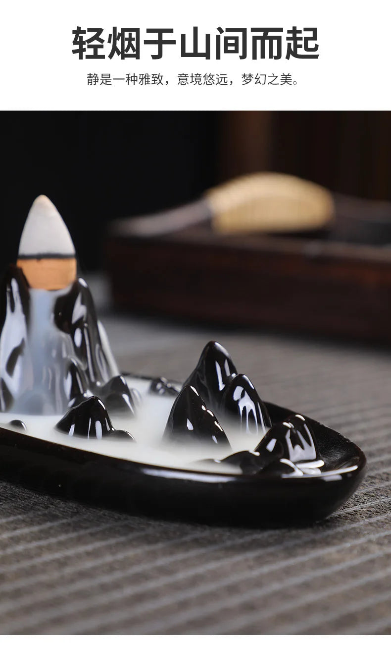 Tower backflow incense burner side view with white cone and smoke over black tray