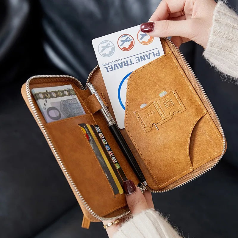 Tan passport sleeve opened to reveal card slots with passport and pen compartments; zip closure