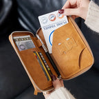 Tan passport sleeve opened to reveal card slots with passport and pen compartments; zip closure