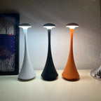 Cordless mushroom touch table lamps in three colors: pearl white, dark blue/black, and amber orange.