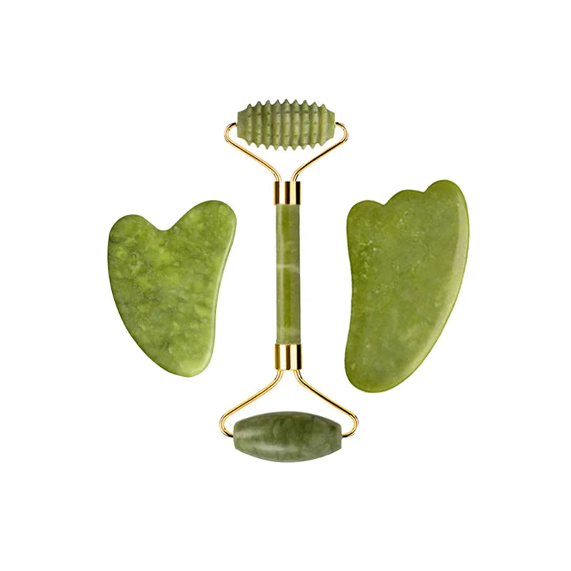 Nephrite jade beauty ritual tools: ribbed roller, heart-shaped gua sha, and flat oval stone