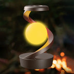 Wireless charging RGB atmosphere lamp with glowing yellow orb and curled gold light ribbon