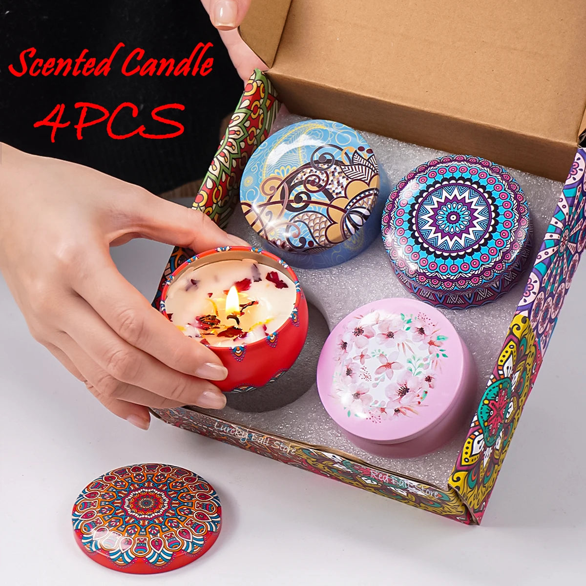 Scented candle tin set with 4 Arabian pattern lids; lit candle in red holder