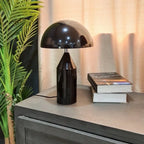 Black mushroom table lamp with black dome shade and glossy black body