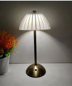 Cordless dimmable night lamp with dome glass shade, vertical ribs, and gold stand